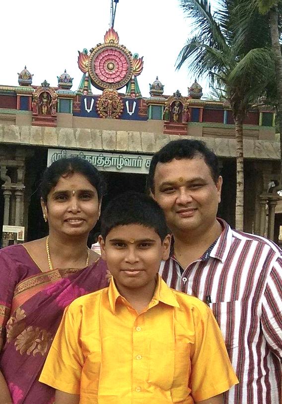 Chennakrishna with wife and son in front of a temple